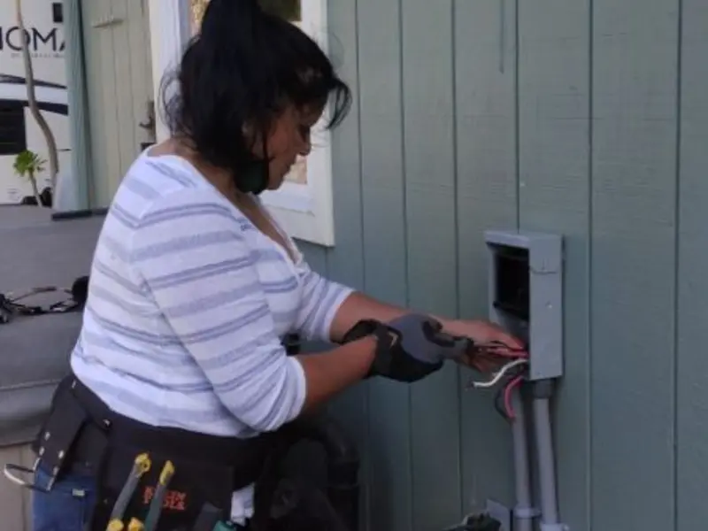 Licensed electrician wiring an exterior subpanel in Wellington